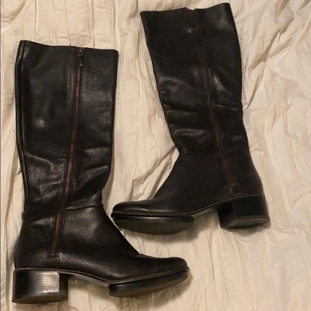 Tall black boots with zipper.